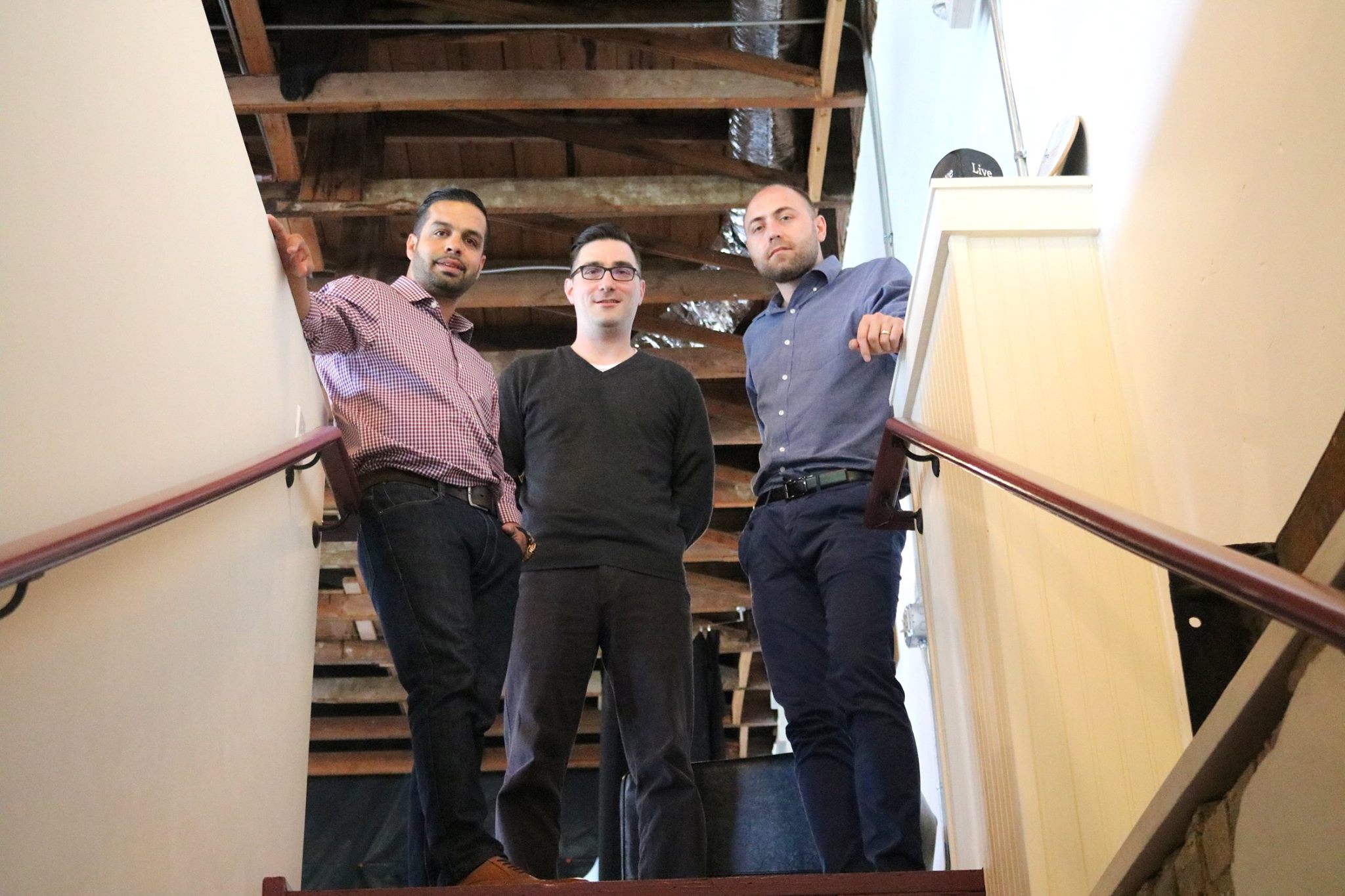 The Lyric founders together on a staircase at the early company headquarters