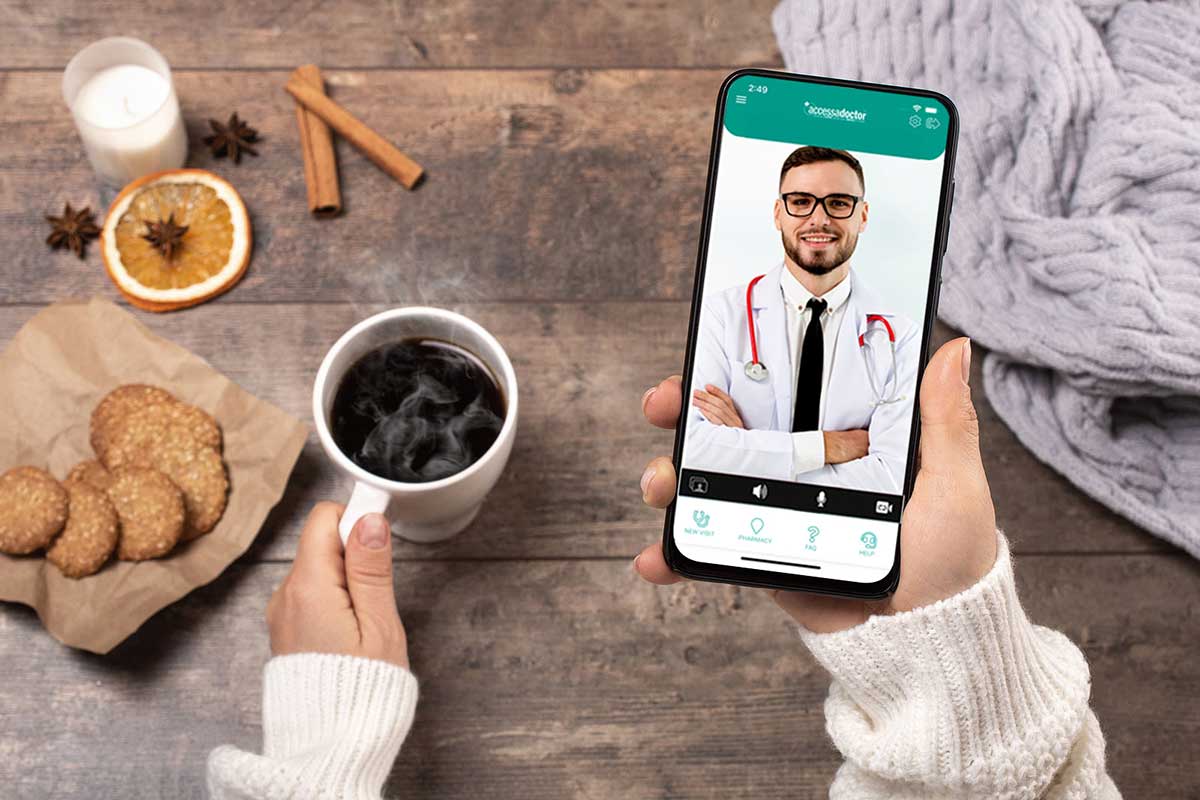 A member relaxes with a coffee and a knit blanket while taking a virtual visit on a partner-branded mobile app powered by Lyric